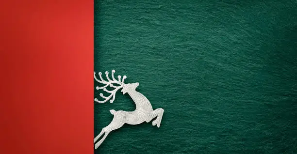 Photo of Reindeer Silhouette over concrete background with copy space