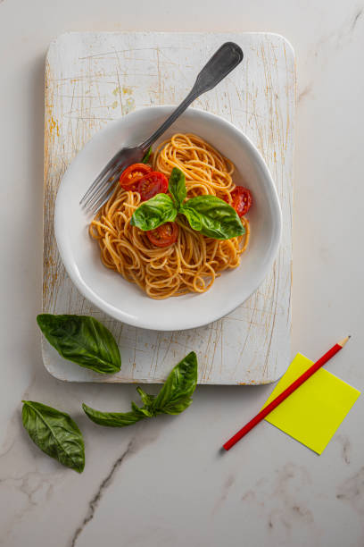 Pasta, spaghetti with tomato sauce in white bowl