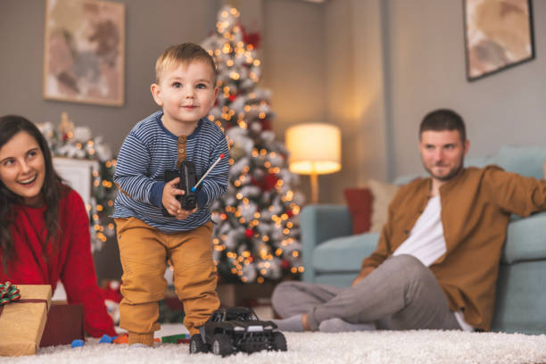 istock Toddler playing with remote controlled car toy he got as Christmas present 1818212935