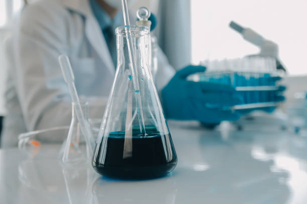 istock biochemical research scientist team working with microscope for coronavirus vaccine development in pharmaceutical research labolatory, selective focus 1818217795
