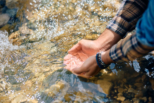 Hand of children get some water for drink from tap, Water scarcity concept.