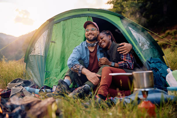 istock Happy couple in love embracing while camping in nature. 1818221427