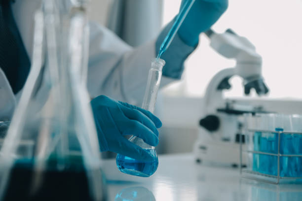 istock biochemical research scientist team working with microscope for coronavirus vaccine development in pharmaceutical research labolatory, selective focus 1818221758