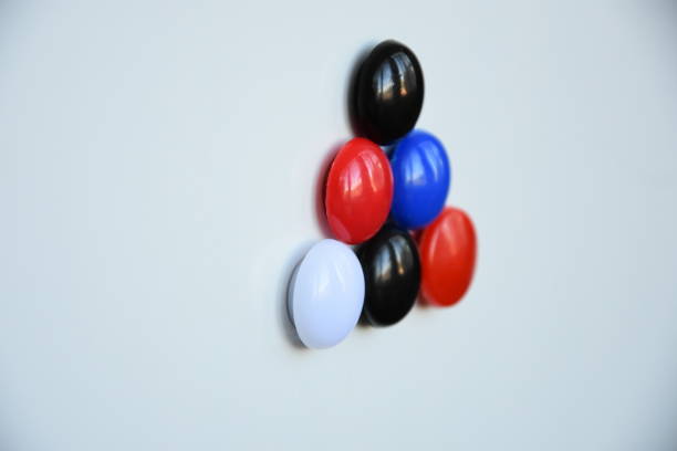 istock figure made of multi-colored small magnets on a white metal background 1818227650