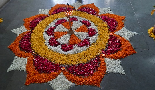 Lamp lighting with flowers rangoli for event, पूजा and starting auspicious events.