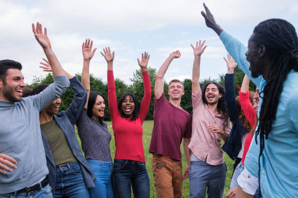 istock Group of young people celebrating successes outdoors lifestyle 1818244983
