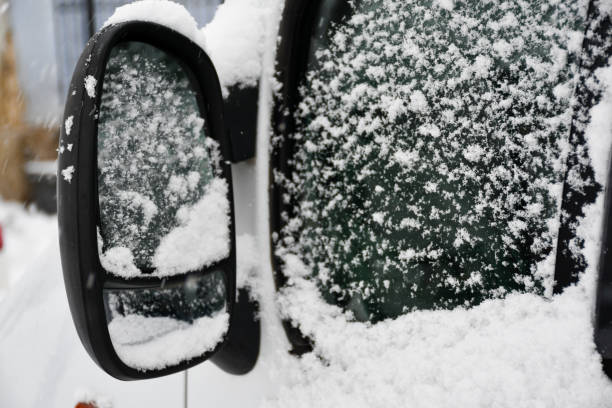 istock Car mirror and window covered with snow 1818246563