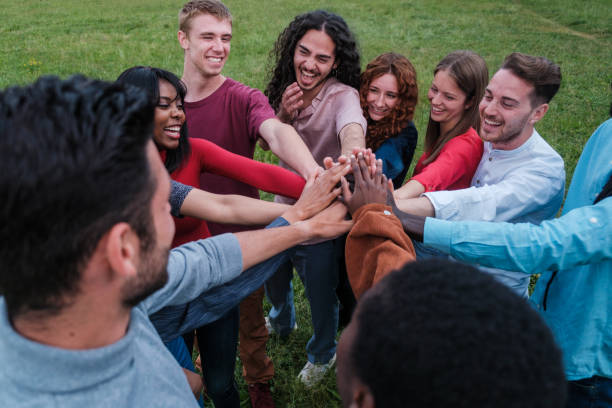 istock Group of culturally diverse friends joining hands representing teamwork 1818251402