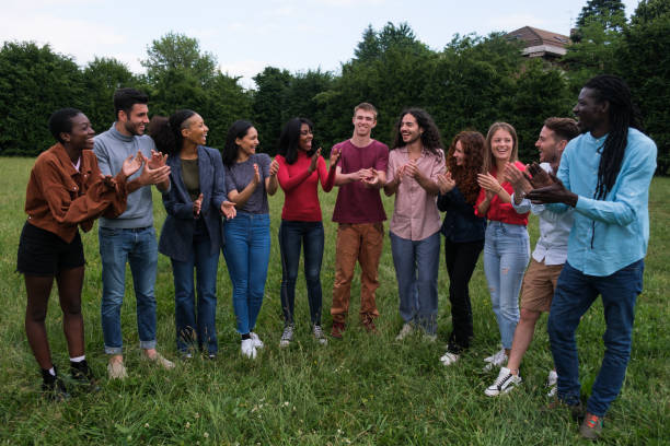 istock Multicultural group of young people clapping hands and having fun together 1818251420