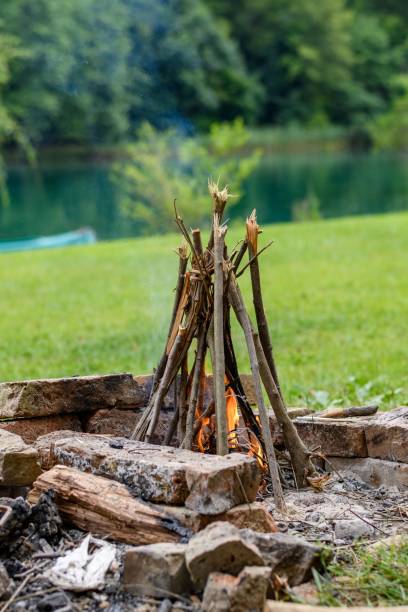 istock Sticks and branches burning on bonfire on river bank 1818256348