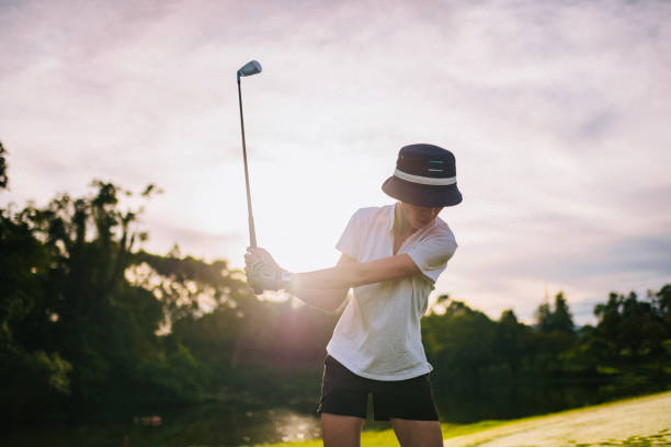 istock Asian female Chinese golfer teeing off in golf course weekend morning 1818263313
