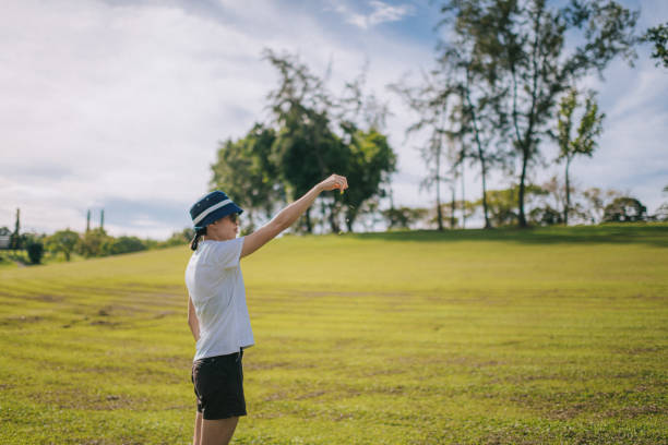 샷을 하기 전 바람의 방향을 확인하고 있는 아시아계 중국인 여성 골퍼 - golf golfer examining wind 뉴스 사진 이미지