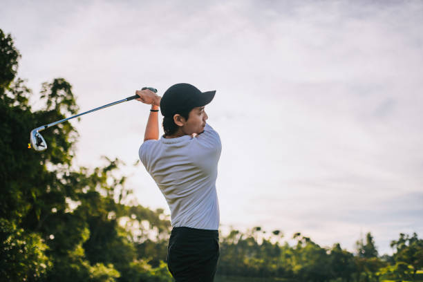 istock Asian Chinese golfer teeing off in golf course weekend morning 1818267869
