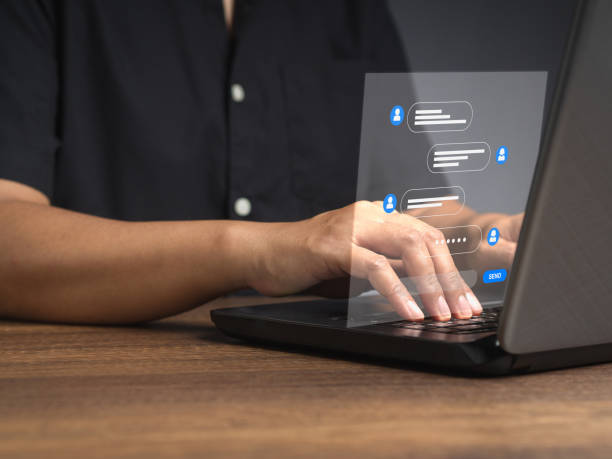 istock Man typing on a keyboard laptop with live chat chatting on application communication digital media websites and social network 1818275338