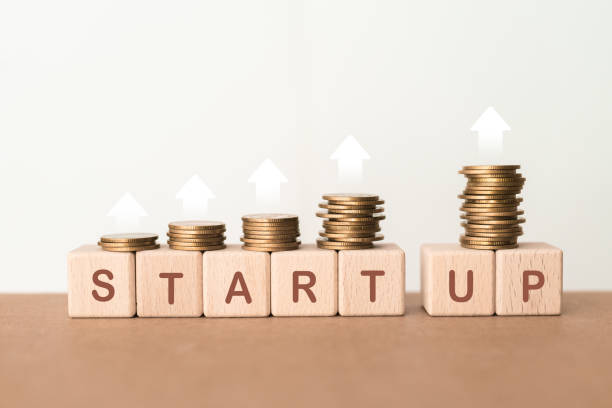 istock START UP text on wooden cube blocks with stack of coin and up arrow, Investor accelerate start-up project concept 1818280205