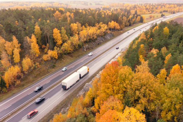istock Truck on a highway through an autumn forest 1818282873