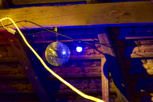 Close-up of light decoration with disco ball inside of barn at Swiss City of Zürich. Photo taken June 23rd, 2023, Zurich, Switzerland.