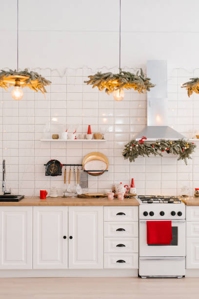 istock Kitchenware and decor on a white shelf in a cozy kitchen with lights. Christmas home decoration 1818330730