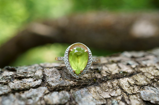 Jewelry ring decorated with chrysolite. Close-up subjects.