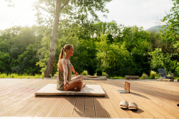 istock Young woman listening a guided meditation online 1818339933