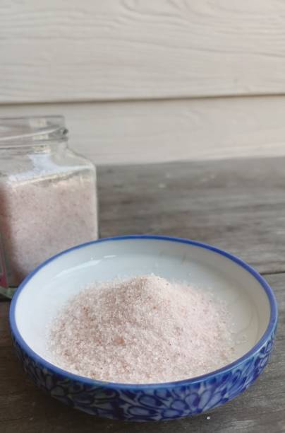 istock Himalayan pink salt on table wood background 1818345805