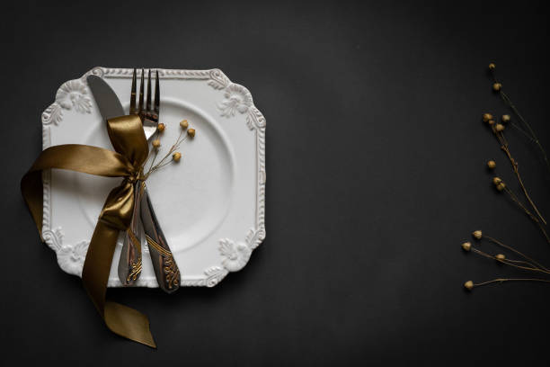 istock Romantic tabble setting with ribbon, plates, cutlery on black background. Empty plate. Mockup design layout for your text. Love romantic concept. Copy space. Top view. Flat lay. 1818354537