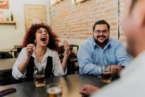 istock Coworkers talking while drinking beer on happy hour at bar 1818356175