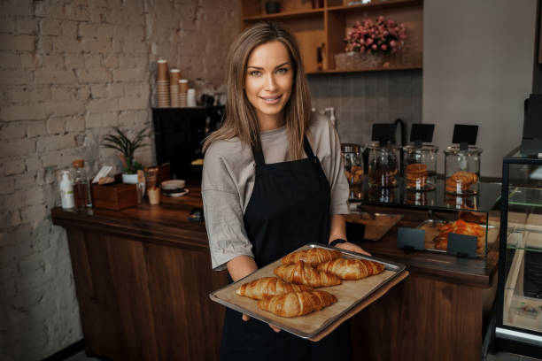 istock Smiling Baker with Fresh Croissants 1818357801