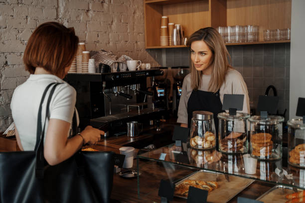 istock Smiling Barista Serving Customer in Coffee Shop 1818364461