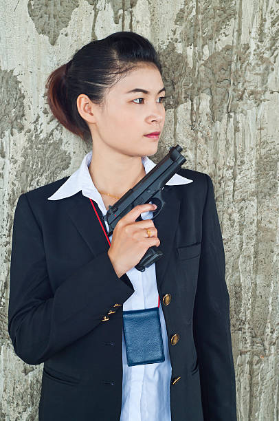 istock Beautiful Asian policewoman in action. 181836488
