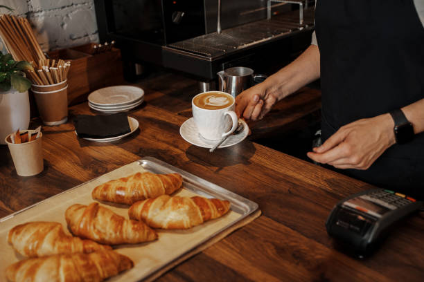 istock Barista Serving Coffee and Croissants 1818365011