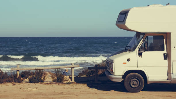 istock Camper car on beach, camping on nature 1818376138