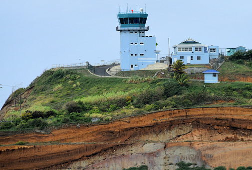 Argyle, Saint Vincent island, Saint Vincent and the Grenadines: hill top air traffic control tower of Argyle International Airport (AIA, IATA SVD) - located 8 km  east of the capital, Kingstown, Argyle International Airport replaced the much smaller E.T. Joshua Airport as St. Vincent and the Grenadines’ principal airport in 2017 - Hub for Air Adelphi, One Caribbean, Mustique Airways, SVG Air.  Rock stata on the geological cut of the hill side.