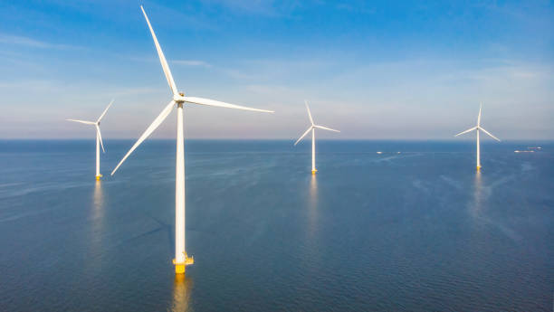 Huge windmill turbines, Offshore Windmill farm in the ocean Westermeerwind park , windmills isolated at sea on a beautiful bright day Netherlands Flevoland Noordoostpolder Windmill farm in the ocean Westermeerwind park, windmills isolated at sea on a beautiful bright day in Netherlands Flevoland Noordoostpolder. Huge windmill turbines at the lake Ijsselmeer in Flevoland offshore wind farm stock pictures, royalty-free photos & images