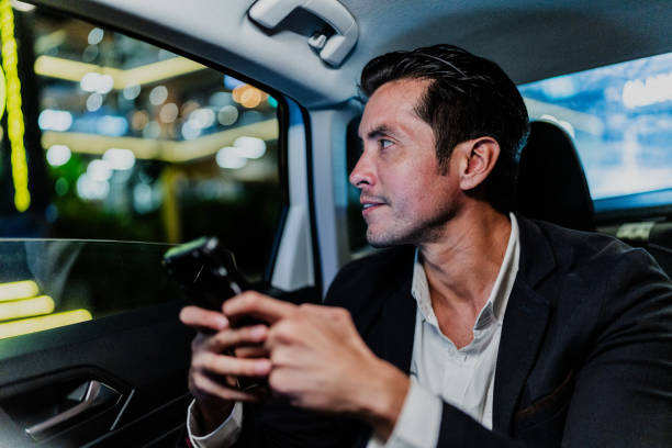 istock Mid adult businessman contemplating while looking through the cab window 1818390851