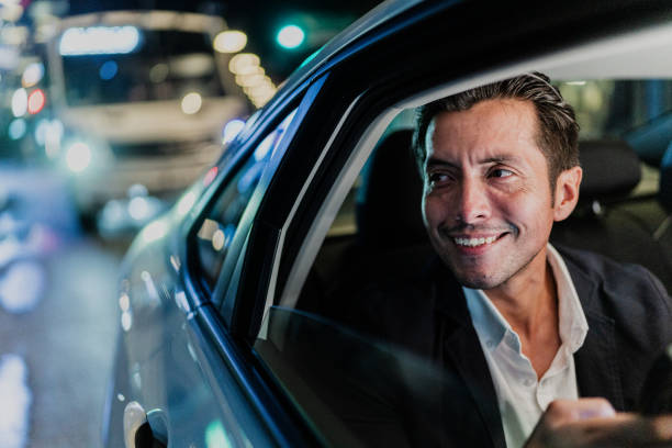 istock Mid adult businessman contemplating while looking through the cab window 1818391371
