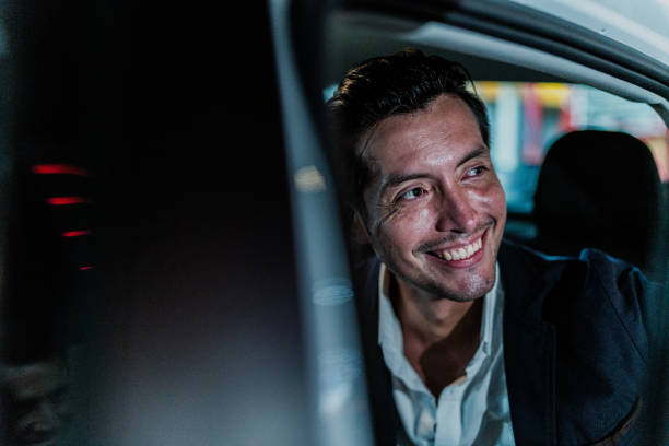 istock Mid adult businessman contemplating while looking through the cab window 1818391388