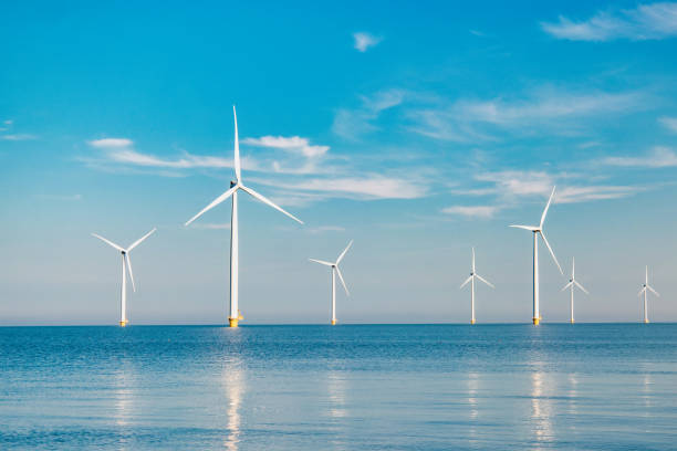 istock offshore windmill park with stormy clouds and a blue sky, windmill park in the ocean 1818391393
