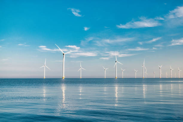 istock offshore windmill park with stormy clouds and a blue sky, windmill park in the ocean 1818392984