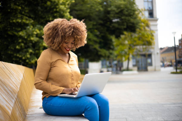 istock Woman Using Laptop Outdoors 1818396783