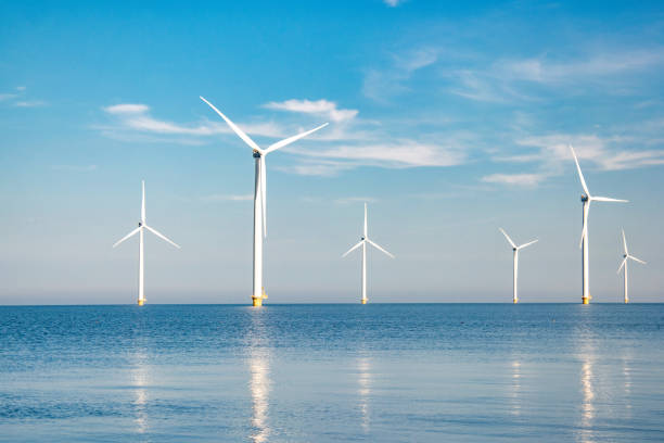 istock offshore windmill park with stormy clouds and a blue sky, windmill park in the ocean 1818397316
