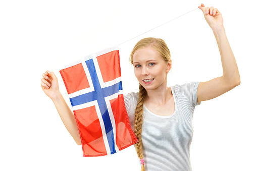 Blonde young woman teen girl braid hair holds norwegian flag. Scandinavian people.