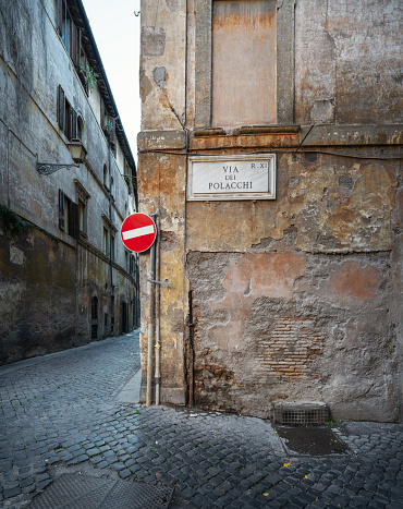 Via dei Polacchi street name sign on a very run-down wall.