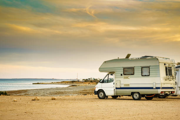 istock Camper car on beach, camping on nature 1818401196