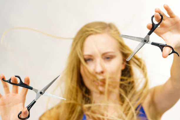 istock Girl with scissors for haircutting 1818403916