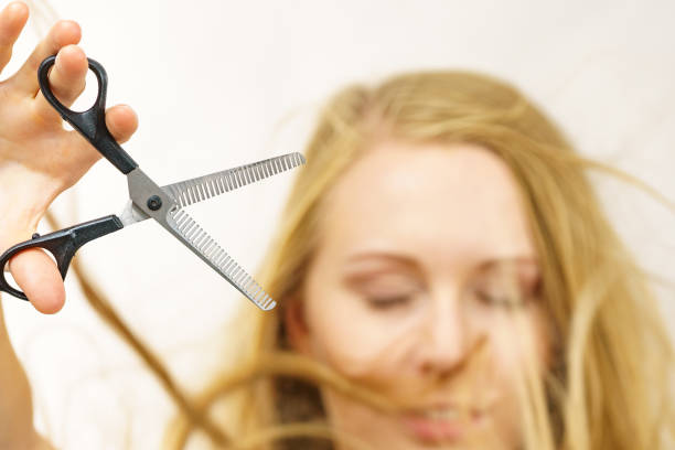 istock Girl with scissors thinning shears 1818404999