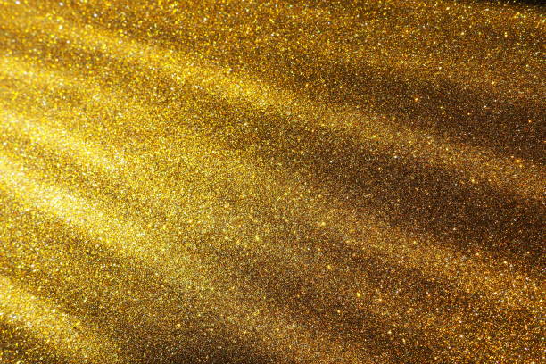 Golden gradient. Dusty gold color. Golden luxury, elegant beauty. Premium abstract background. Shiny, shimmering. Christmas, Happy New Year or birthday. Oblique light rays, photons and radiation. stock photo