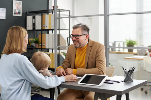istock Young mother talking to social worker in office 1818414028