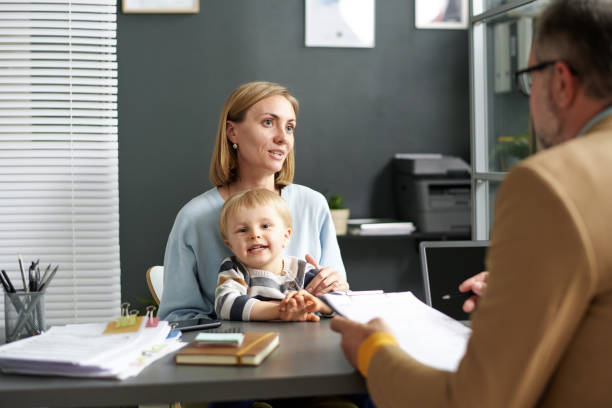 istock Woman with child talking to social worker 1818415172