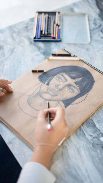 istock Close-up young painter woman doing pencil drawing 1818415187